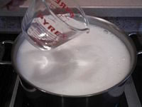 Drizzle Dissolved Coagulant over the top of the soymilk